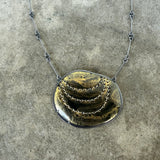 black and gold stitch enamel pendant