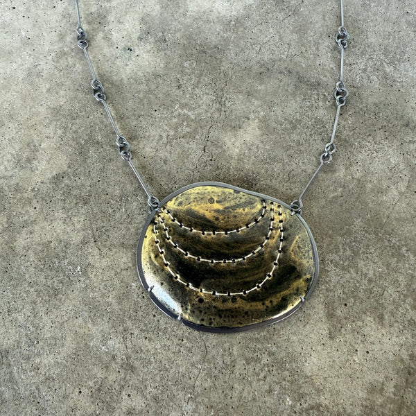 black and gold stitch enamel pendant