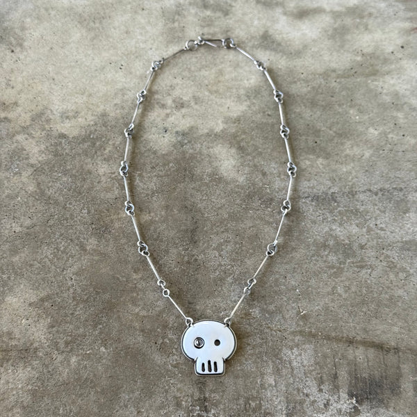 white enamel skull necklace with diamond
