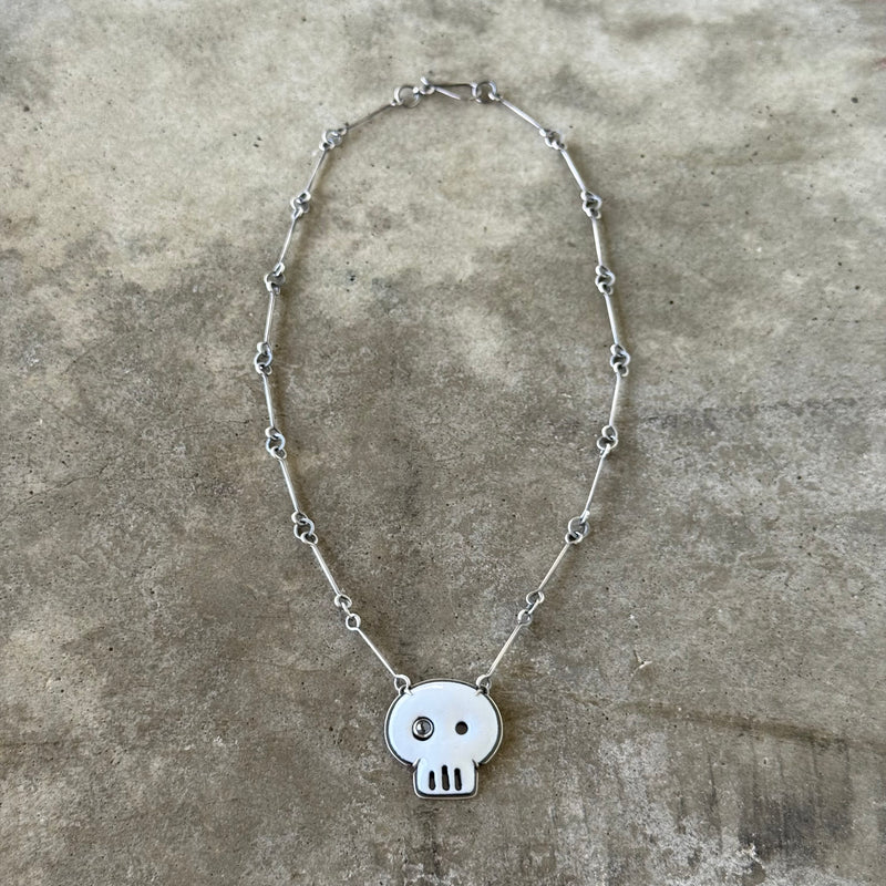 white enamel skull necklace with diamond