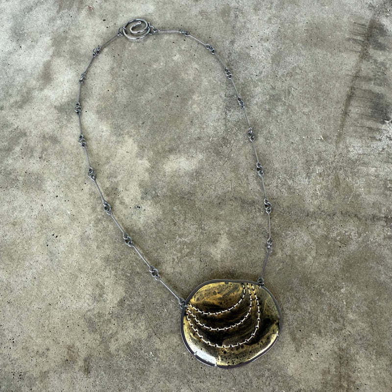 black and gold stitch enamel pendant