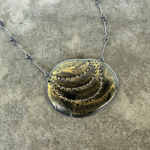 black and gold stitch enamel pendant