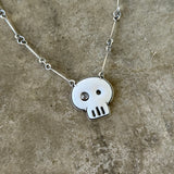 white enamel skull necklace with diamond