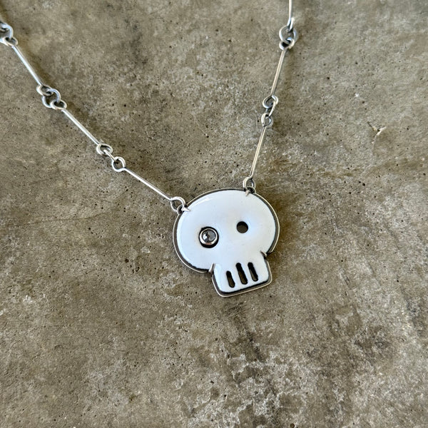 white enamel skull necklace with diamond