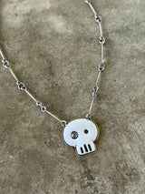 white enamel skull necklace with diamond